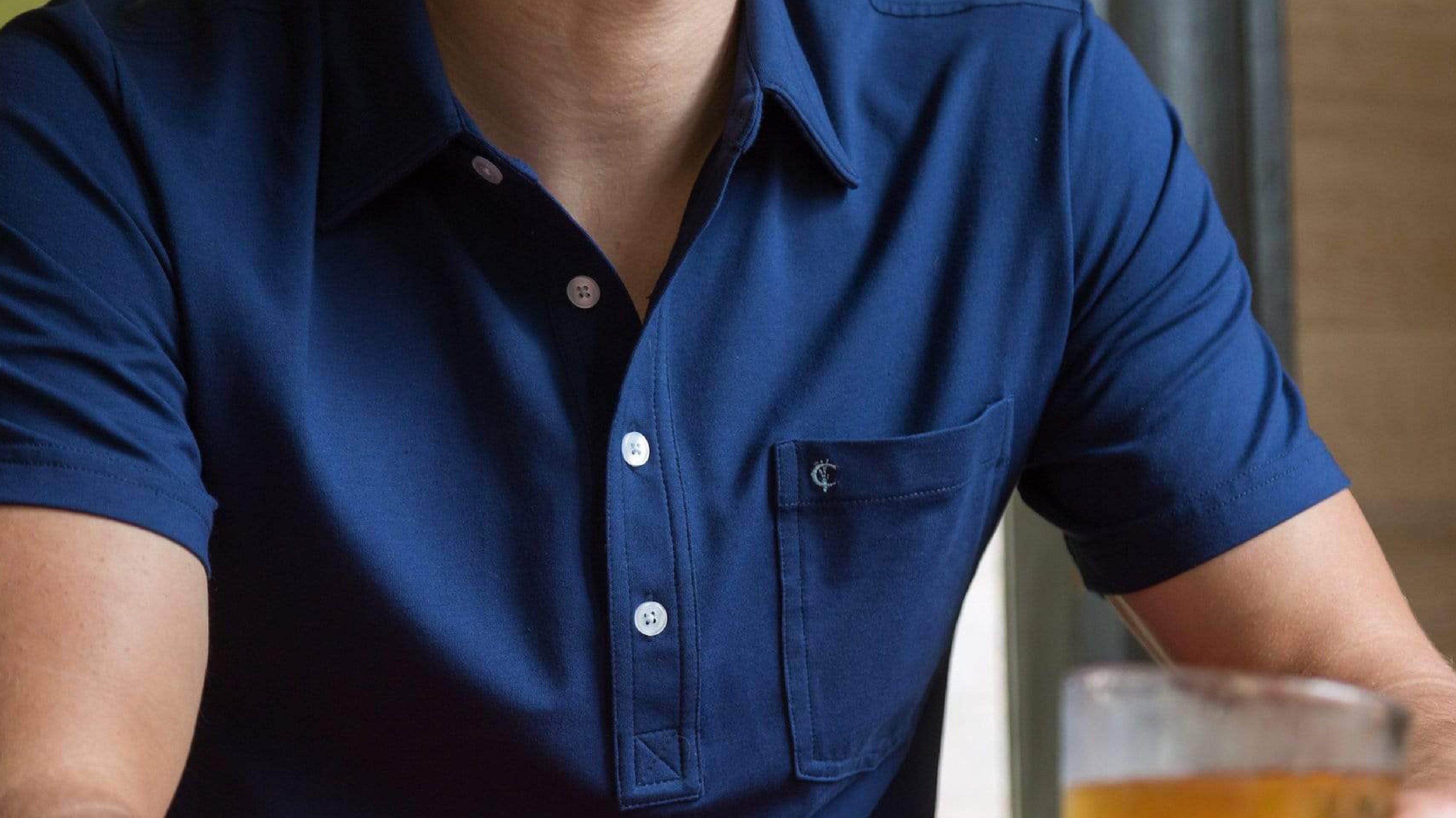 Man wearing Criquet Top Shelf Polo in Navy Blue.