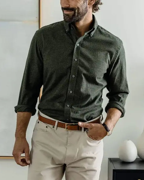 Man wearing a dark green houndstooth button down casual shirt