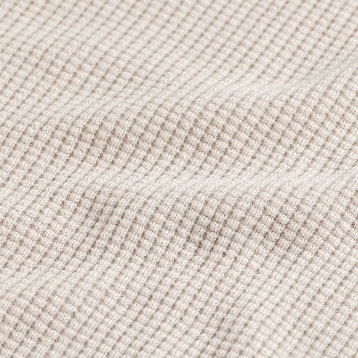 Closeup of the fabric of the men's waffle knit merino wool Walden sweater by Ledbury showing soft folds