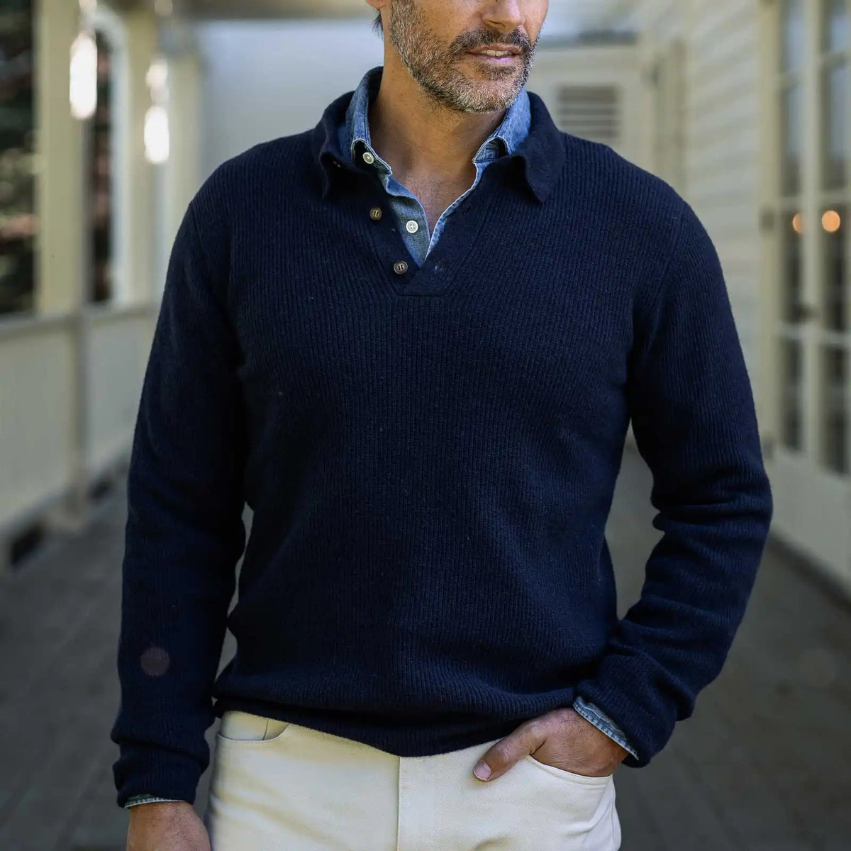 Men's Navy Atwood polo sweater styled with chinos — lifestyle shot