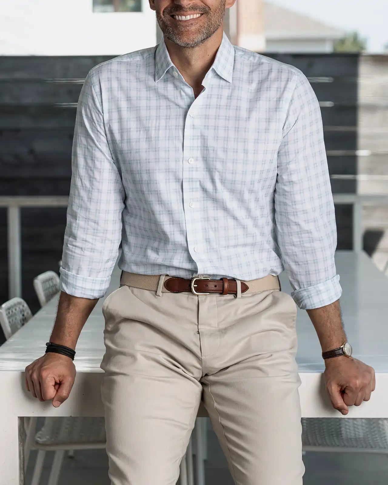 Man wearing the light green Ellis checkered shirt and beige pants, standing in an outdoor setting.