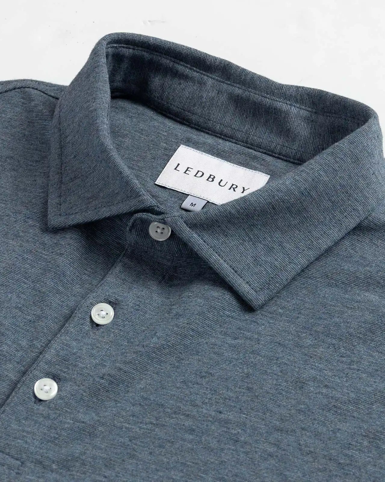 Close-up of the collar on the Ledbury Freeman Knit Custom Polo in Bay Blue