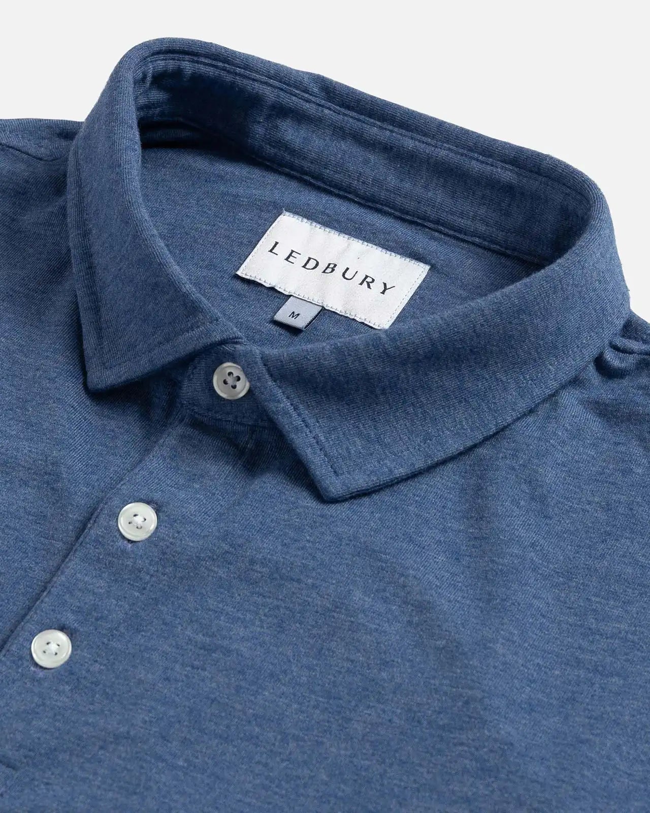 Close-up of the collar on the Ledbury Freeman Knit Custom Polo in Blue