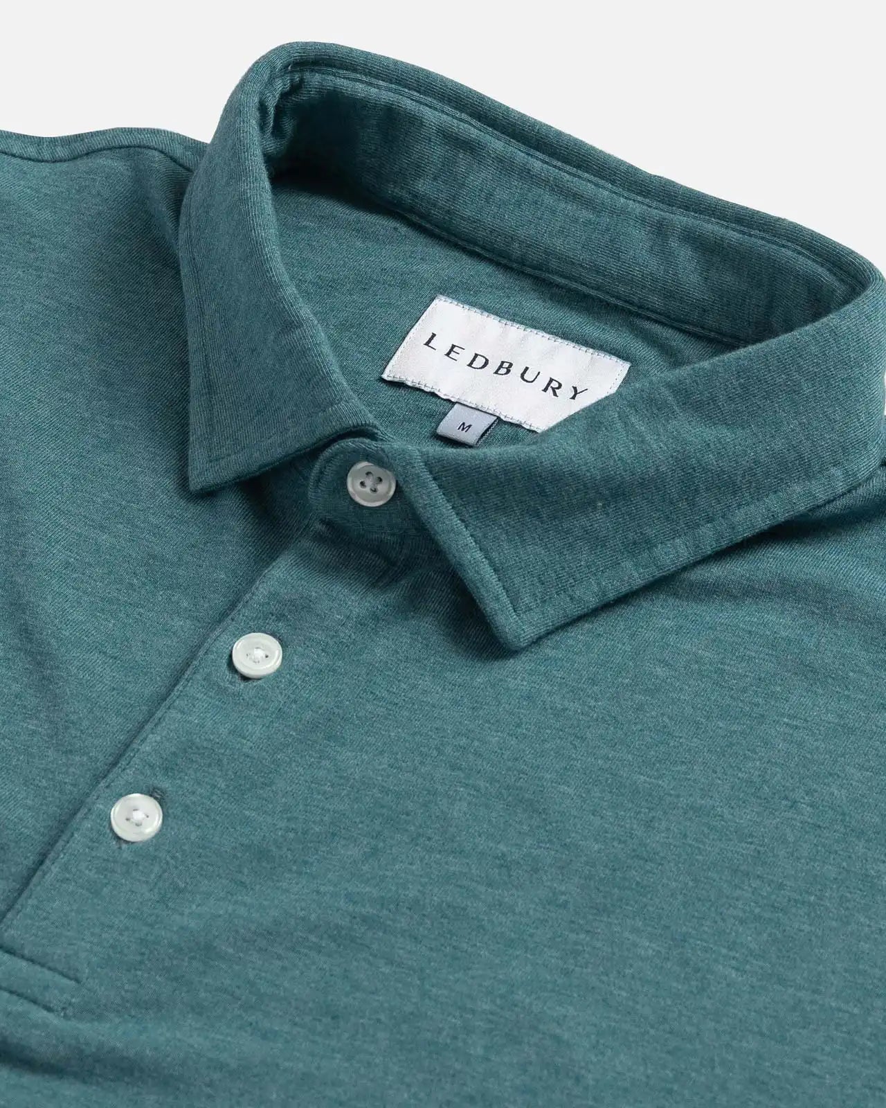 Close-up of the collar on the Ledbury Freeman Knit Custom Polo in Teal