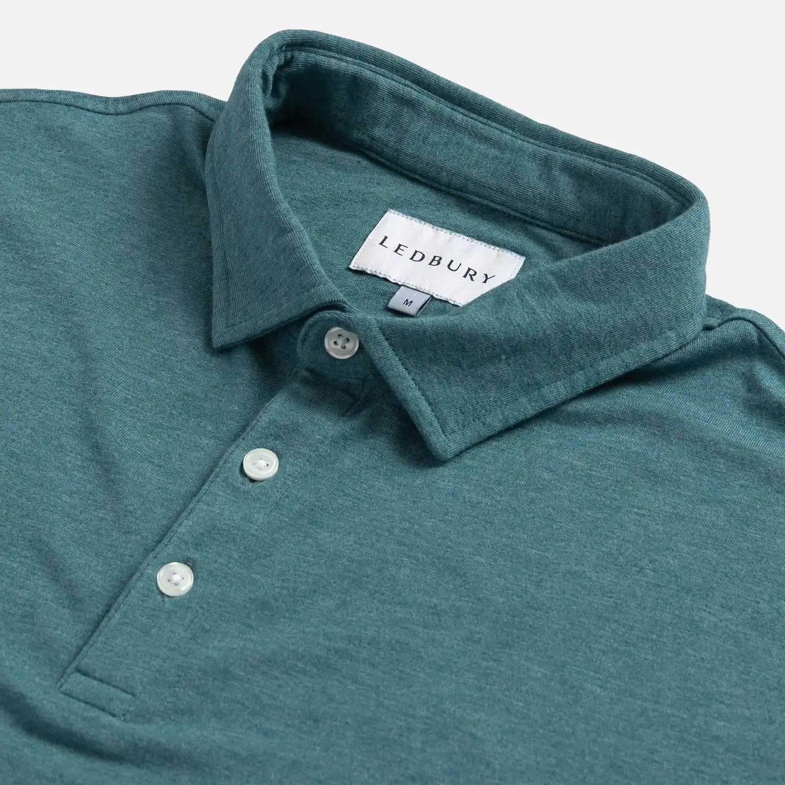 Close-up of the collar on the Ledbury Freeman Knit Custom Polo in Teal