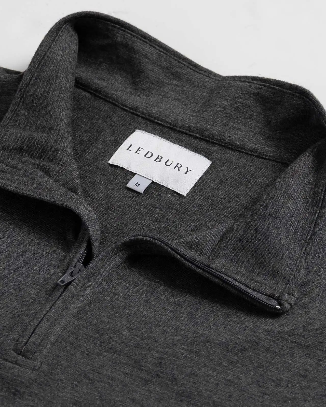 Close-up of quarter-zip collar and Ledbury label on Freeman Sport Quarter Zip in Charcoal Grey
