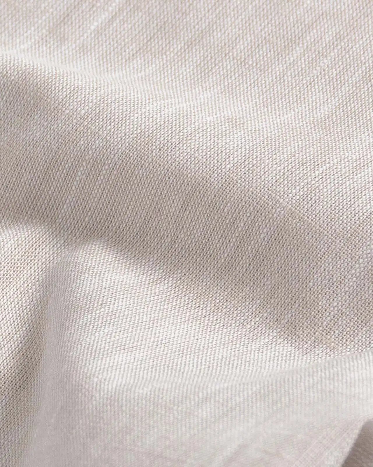 Close-up of slub cotton oxford chambray fabric — subtle heathered texture on the Ecru Sandoval