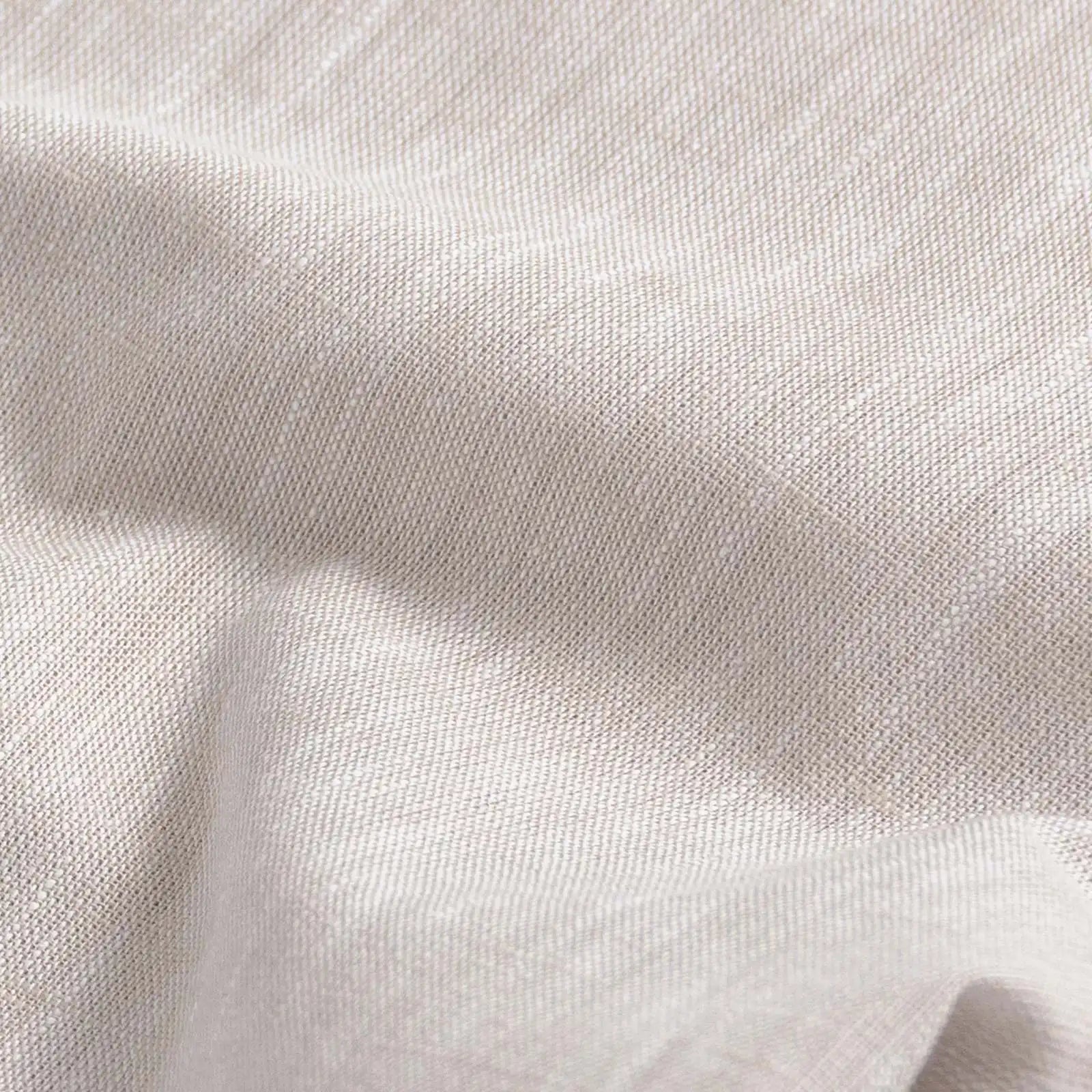 Close-up of slub cotton oxford chambray fabric — subtle heathered texture on the Ecru Sandoval