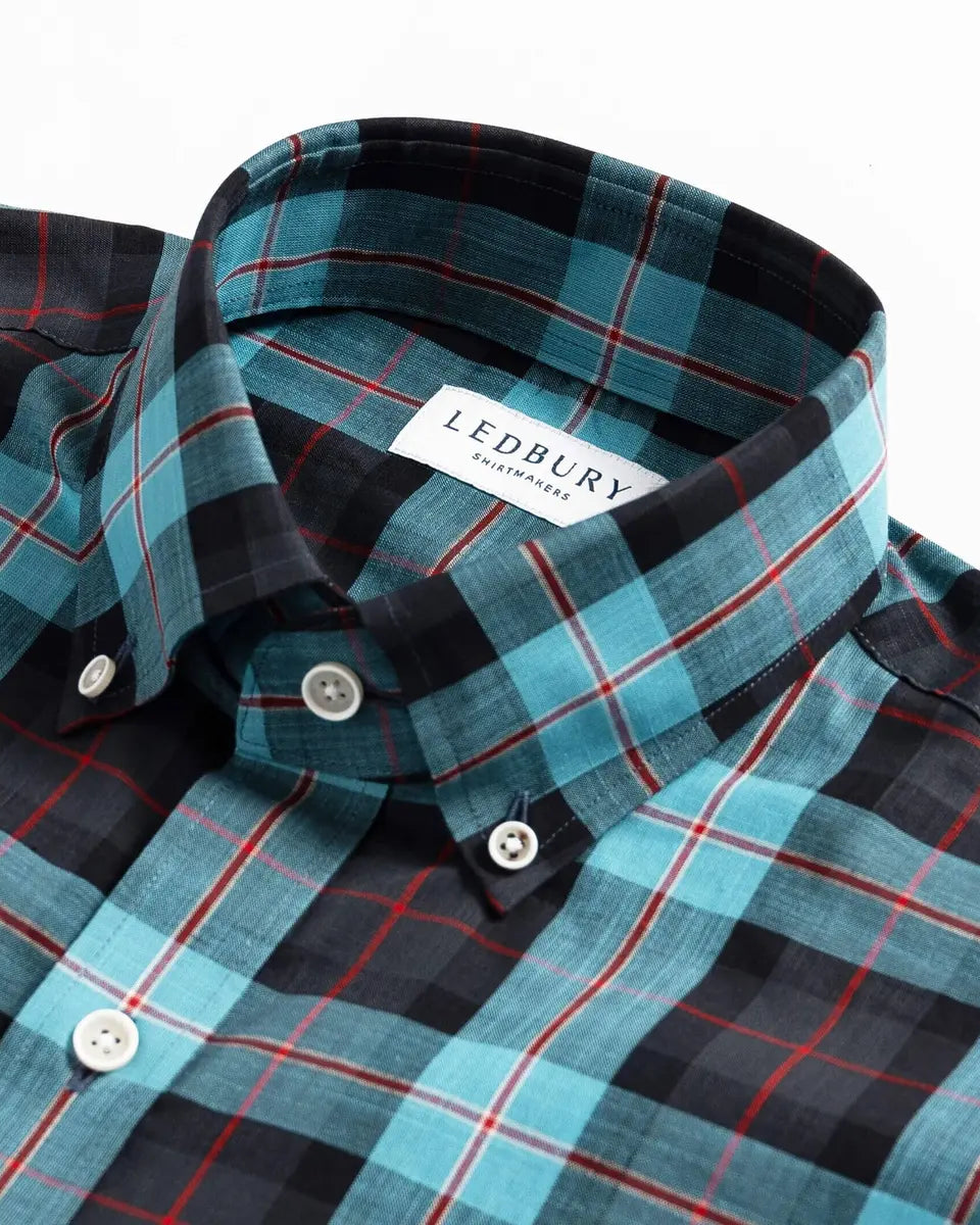 Close-up of Ledbury Blue Albini Olson Plaid shirt collar and button placket detail, teal and navy plaid fabric