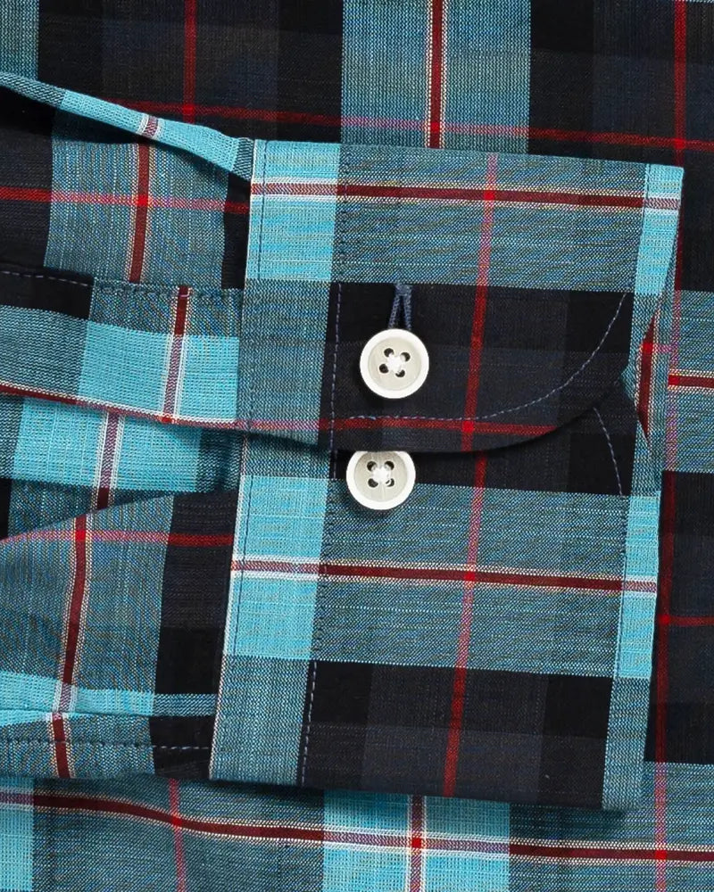 Close-up of Ledbury Olson Plaid double button barrel cuff in teal and navy plaid cotton chambray