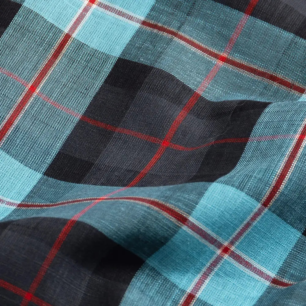 Close-up of Ledbury Blue Albini Olson Plaid 100% cotton chambray fabric texture, teal navy and red plaid weave