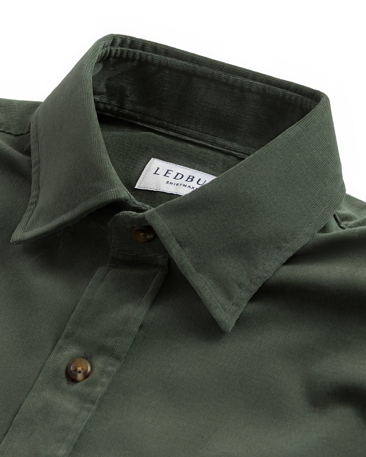 Close-up of a dark olive green button-down shirt collar with a visible Ledbury label, set against a plain white background.