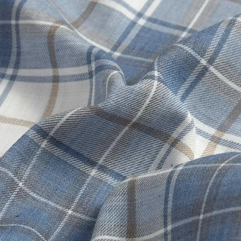 Fabric detail of the Ledbury Faded Blue Coulter Plaid Custom Shirt — lightweight Japanese recycled polyester and organic cotton blend