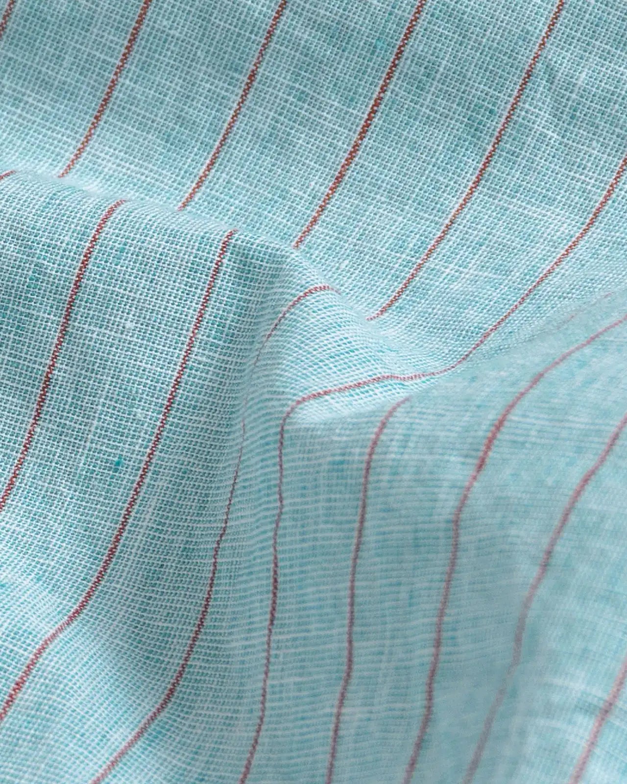 Close-up of sea green stripe fabric texture on the Barretto cotton-linen shirt