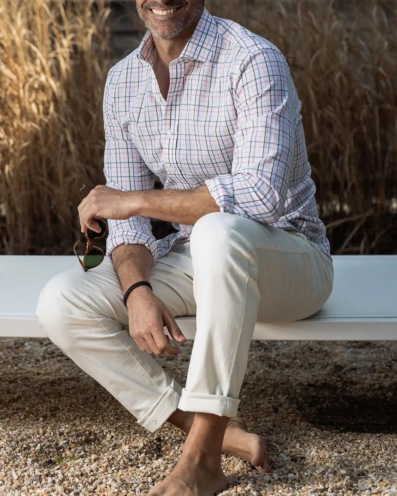 Man wearing the Ledbury Peach Santos Check shirt outdoors — peach, blue, and olive cotton seersucker check