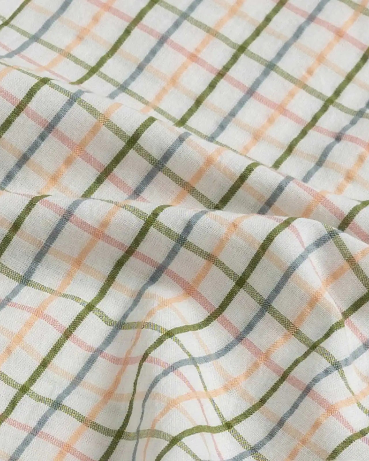 100% cotton seersucker fabric detail of the Peach Santos Check shirt — peach, blue, and olive check