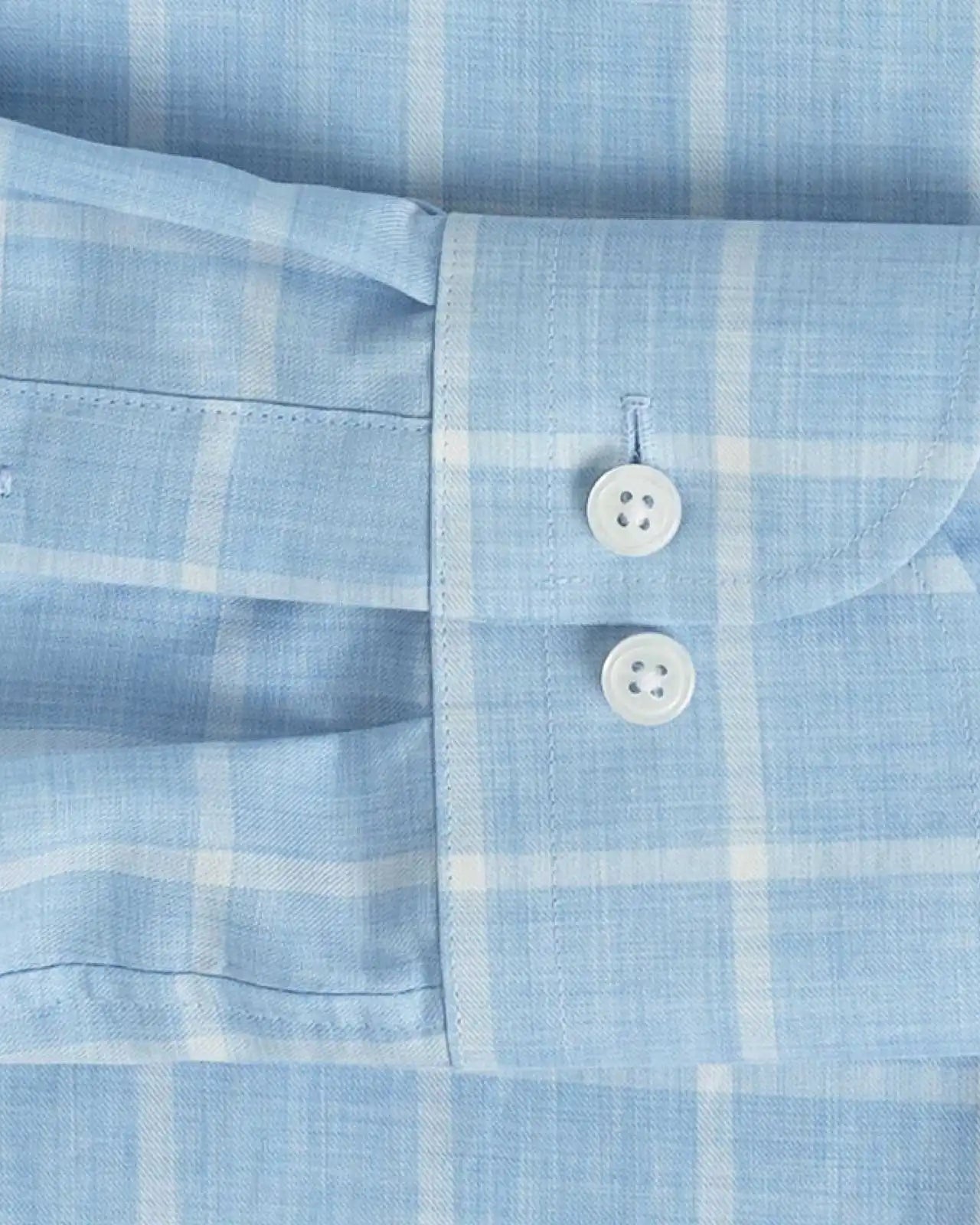 Sleeve detail of an Italian Albini light blue and white checkered button down shirt