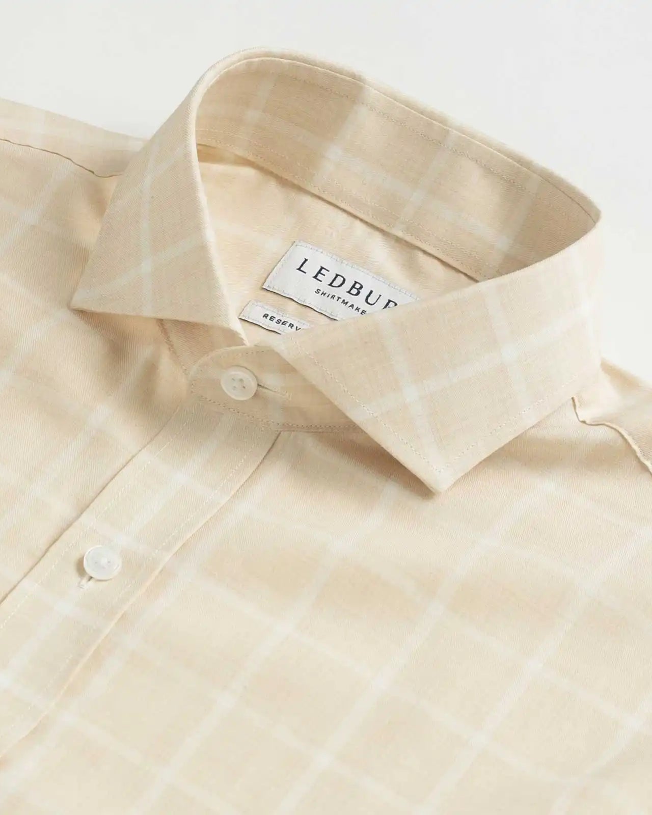 Collar detail of an Italian Albini cream and white checkered button down shirt