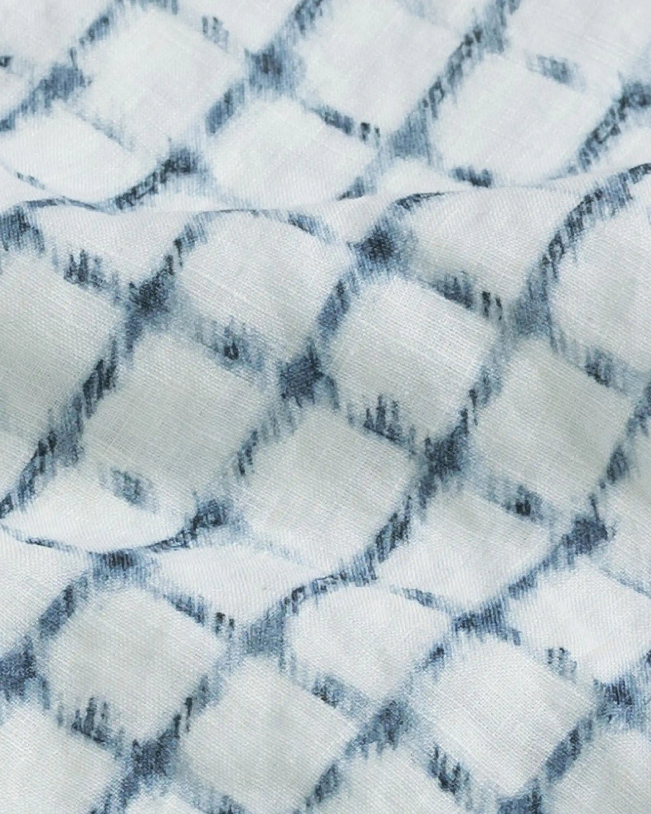 Close-up of a textured Italian linen fabric with a check pattern in white and blue.