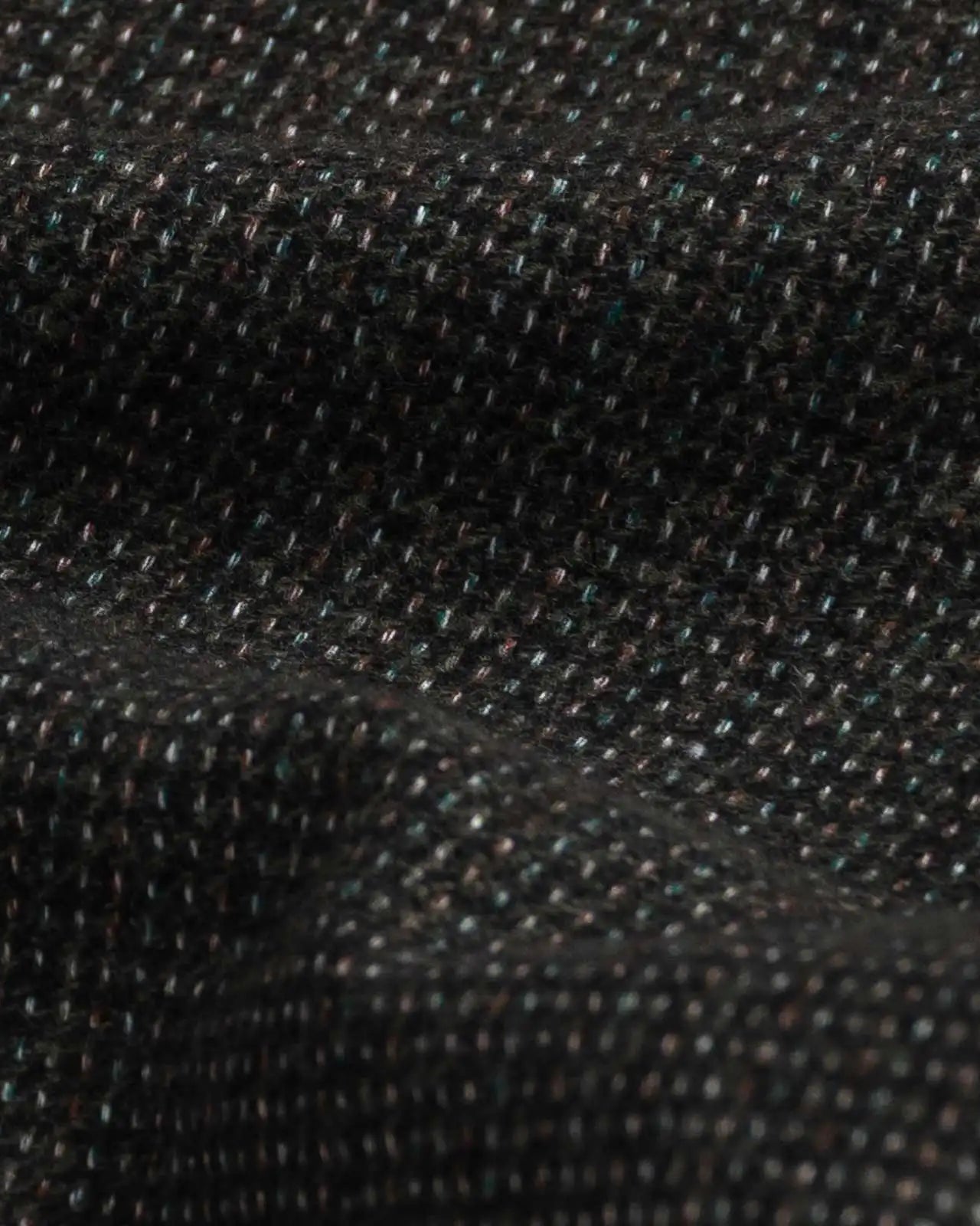 Dark green Delange dobby fabric close-up - luxurious textured weave pattern