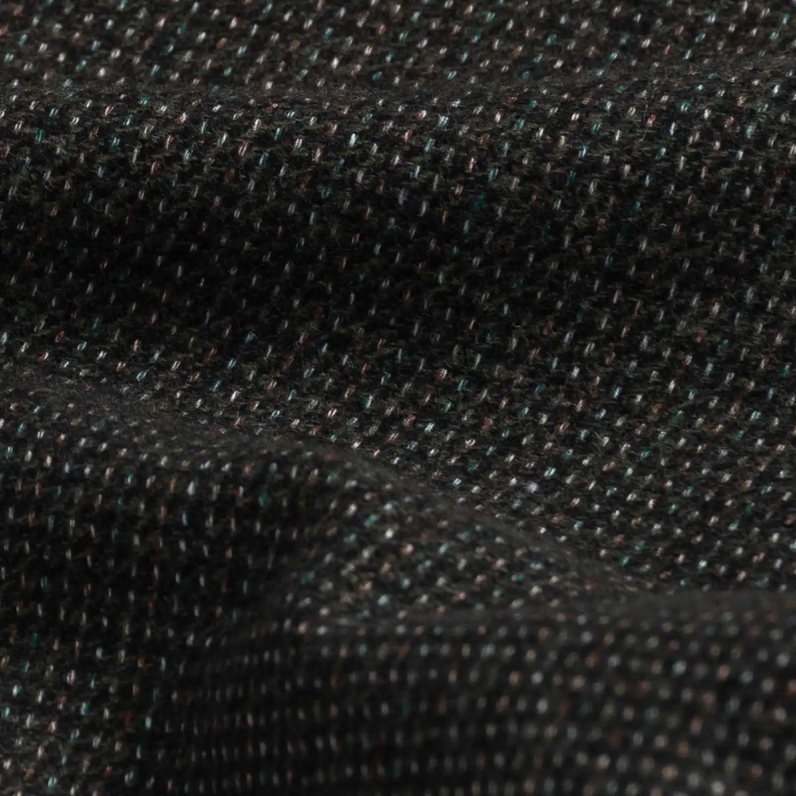 Dark green Delange dobby fabric close-up - luxurious textured weave pattern