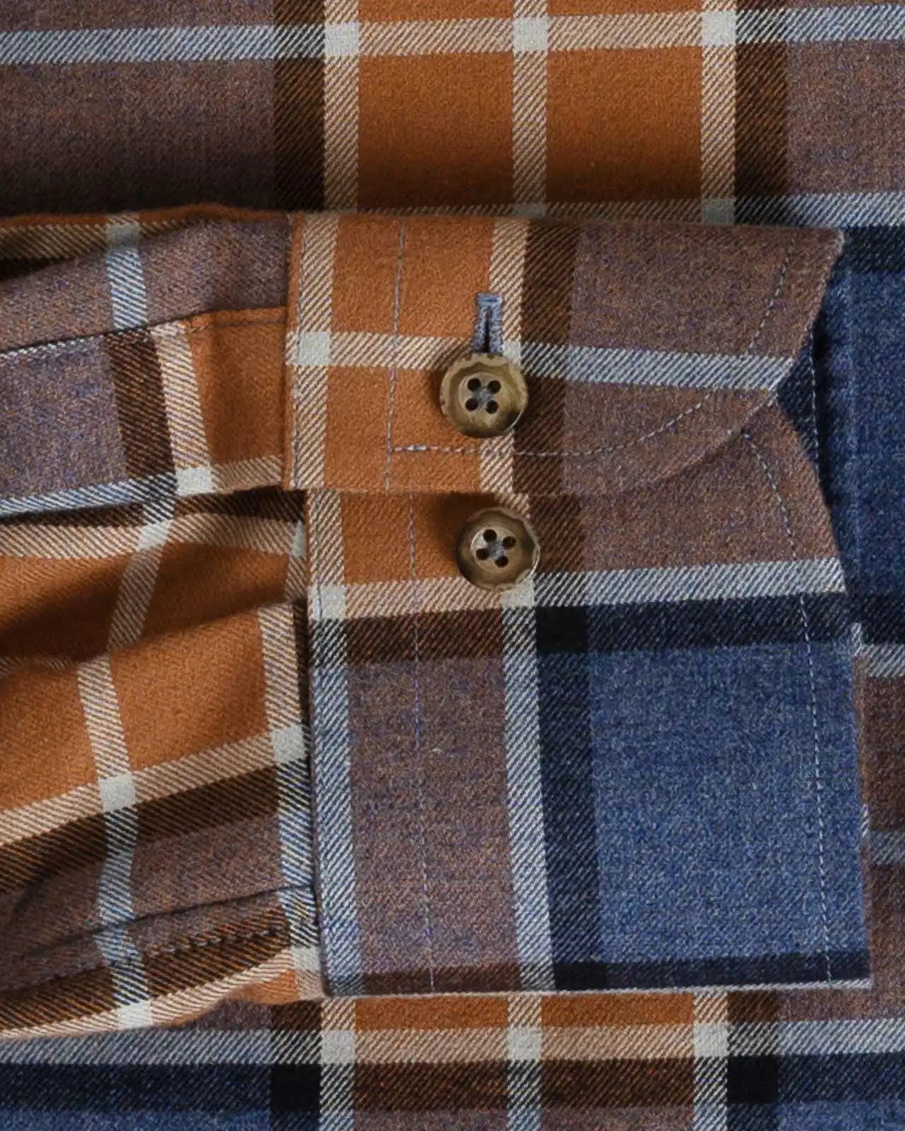 Orange and navy plaid flannel custom shirt cuff and sleeve detail