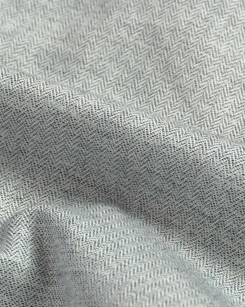 Close-up of gray fabric with a subtle herringbone pattern