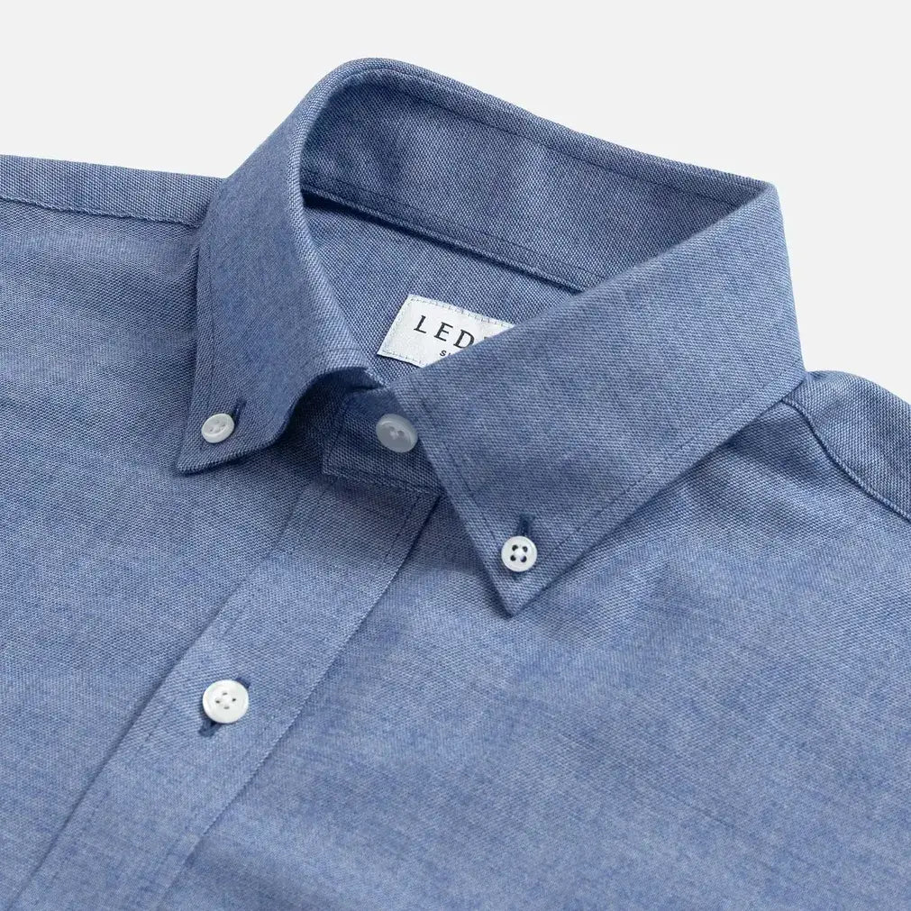 Close-up of a blue brushed oxford shirt with collar and buttons