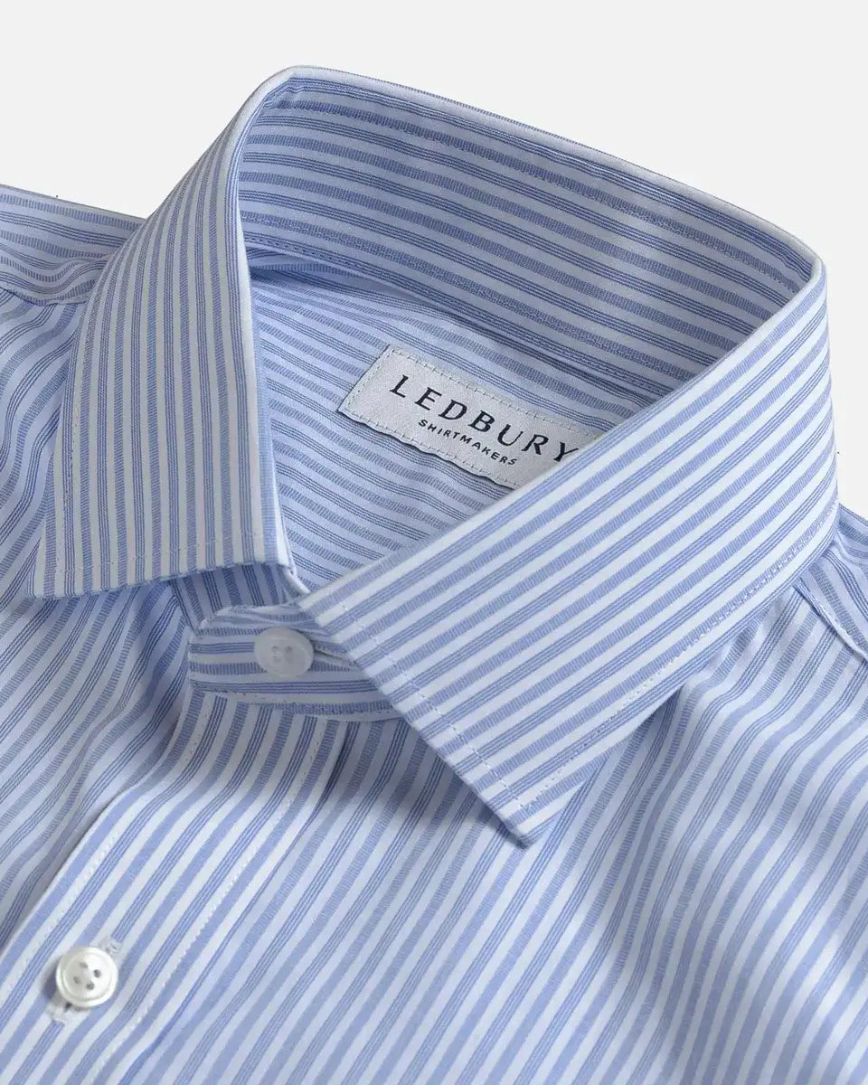 Close-up of a Ledbury men's dress shirt in a light blue and white stripe pattern, showing the collar, button, and brand label.