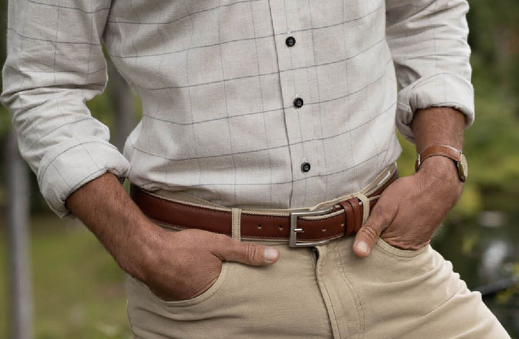Man wearing tan dress pants, a flannel shirt and a light brown leather belt
