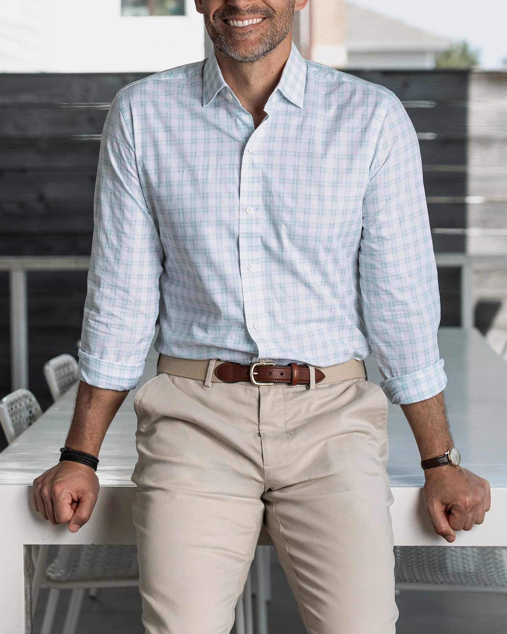 Man wearing the light green Ellis checkered shirt and beige pants, standing in an outdoor setting.