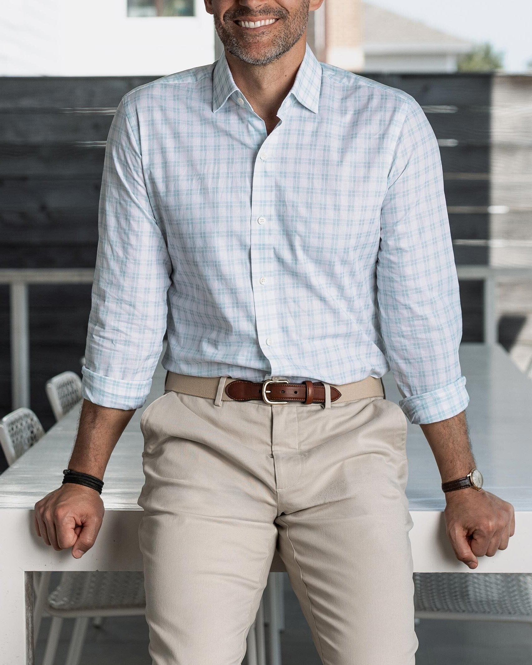 Man wearing the light green Ellis checkered shirt and beige pants, standing in an outdoor setting.