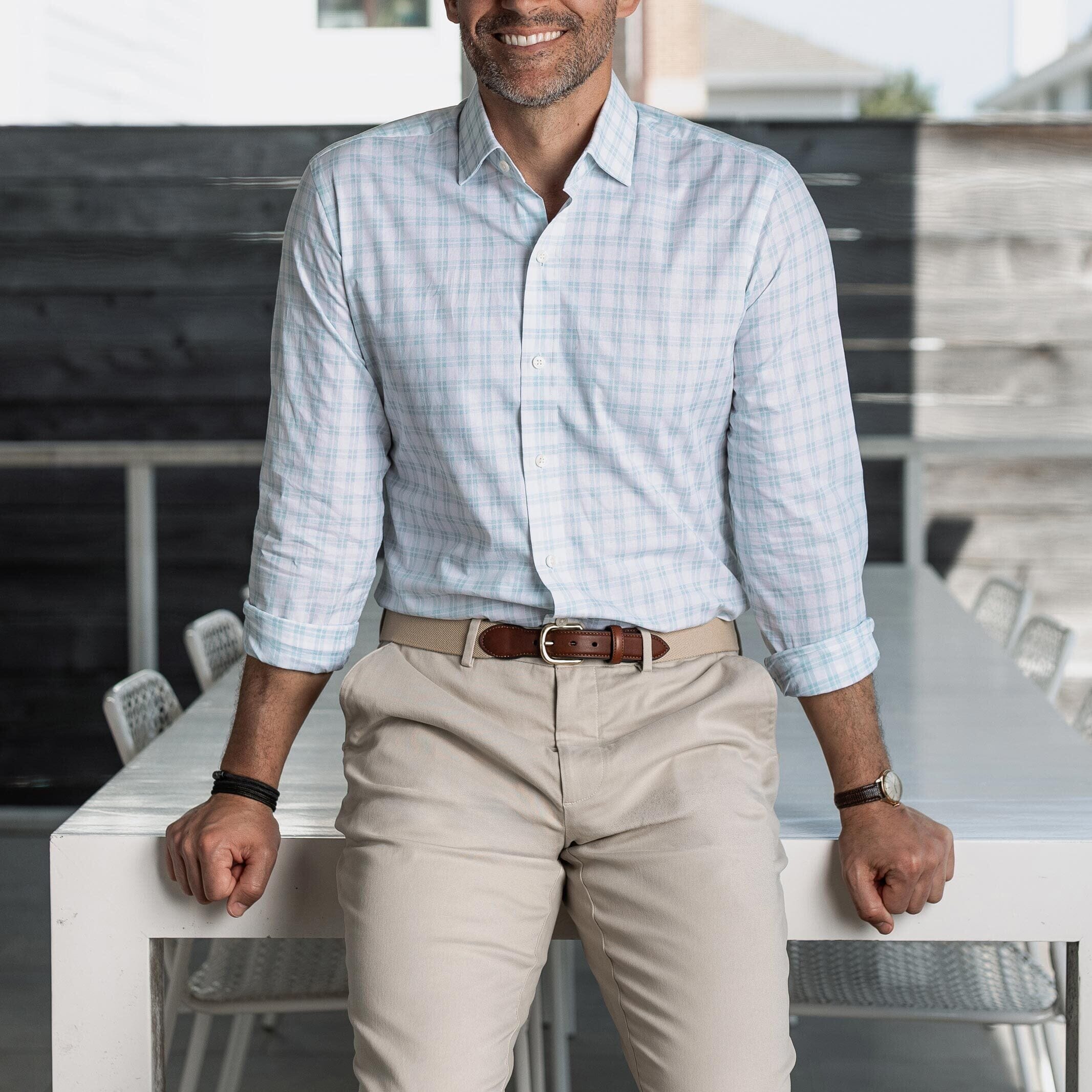 Man wearing the light green Ellis checkered shirt and beige pants, standing in an outdoor setting.