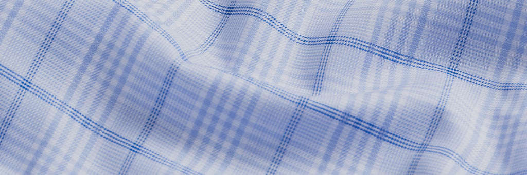 Closeup of the fabric of a cotton stretch dress shirt in a blue check pattern 
