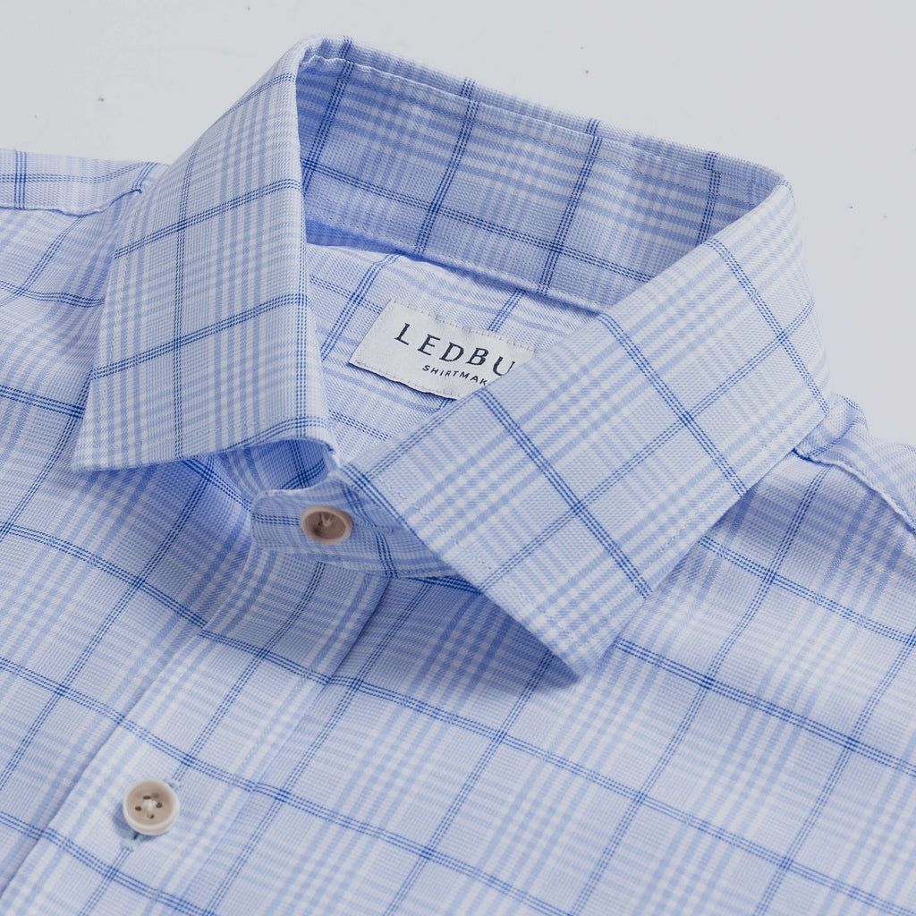 Closeup of the collar of a men's cotton stretch blue check dress shirt 