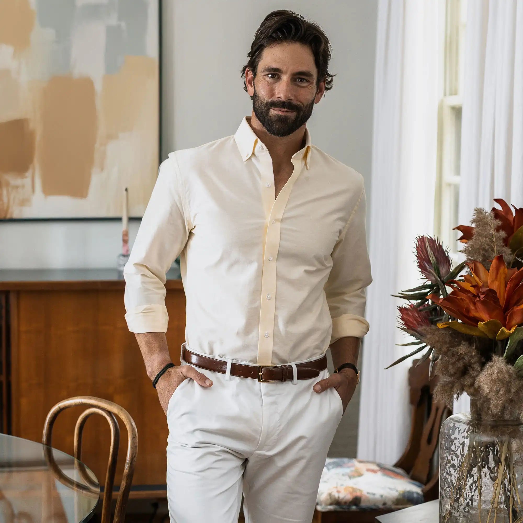 Male model wearing a cream chambray button down shirt by Ledbury