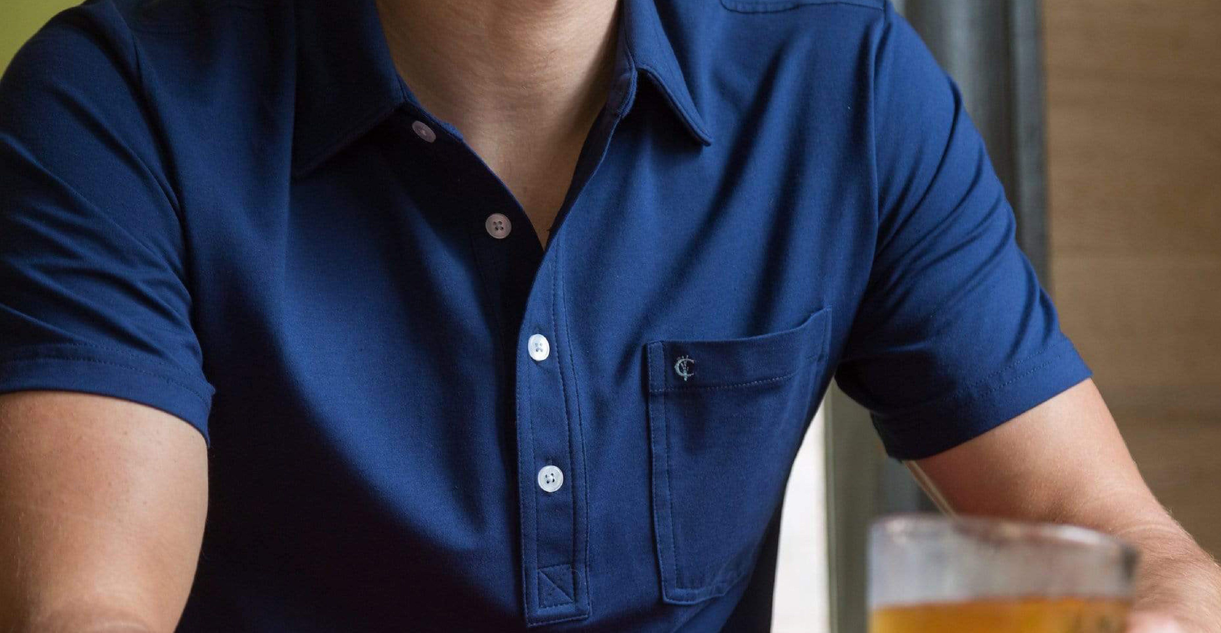 Man wearing Criquet Top Shelf Polo in Navy Blue.