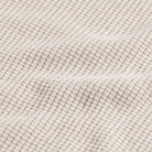 Closeup of the fabric of the men's waffle knit merino wool Walden sweater by Ledbury showing soft folds 