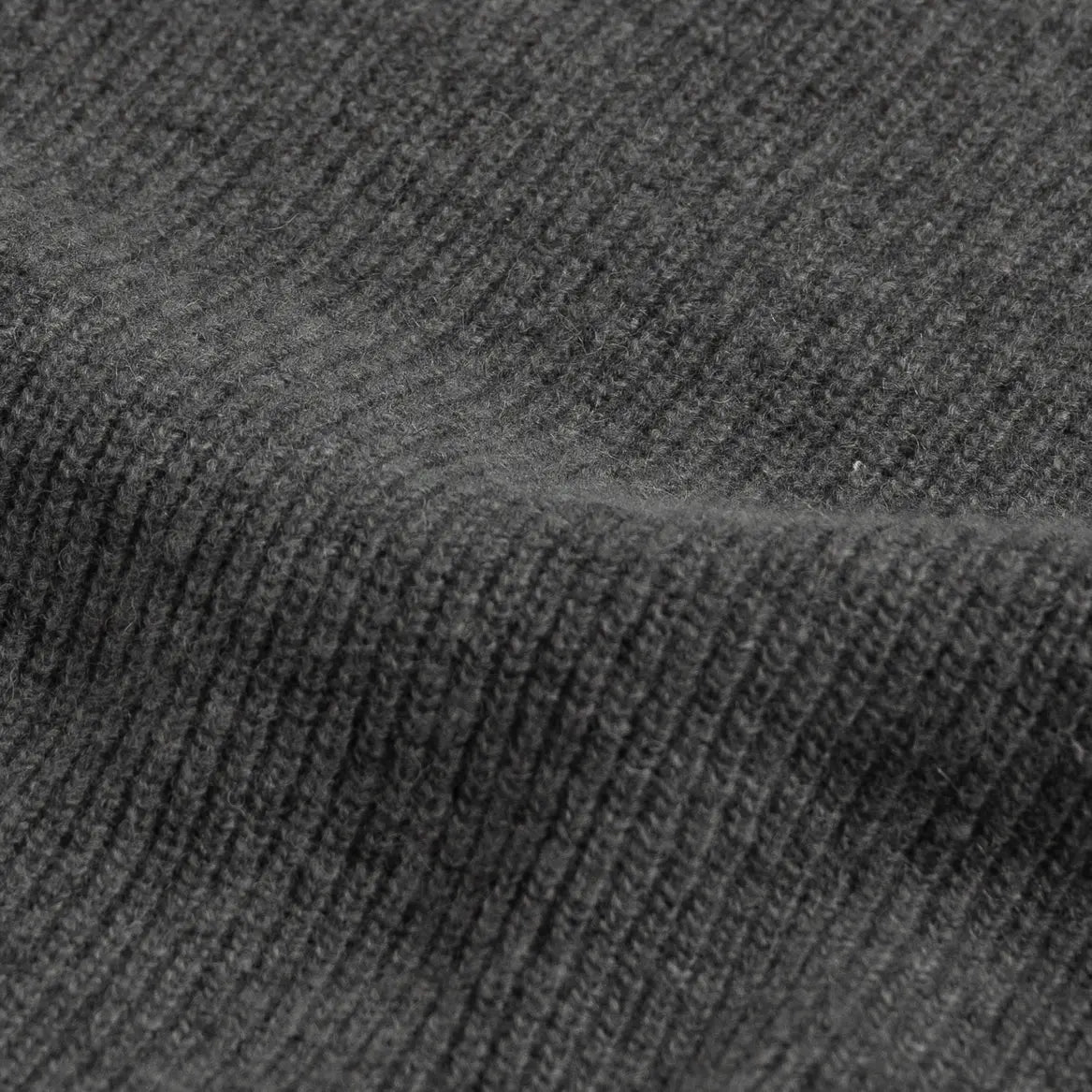 Close-up of a charcoal gray ribbed knit fabric texture.