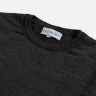 Close-up of a dark charcoal gray crewneck sweater with a visible white LEDBURY neck label, set against a light gray background.