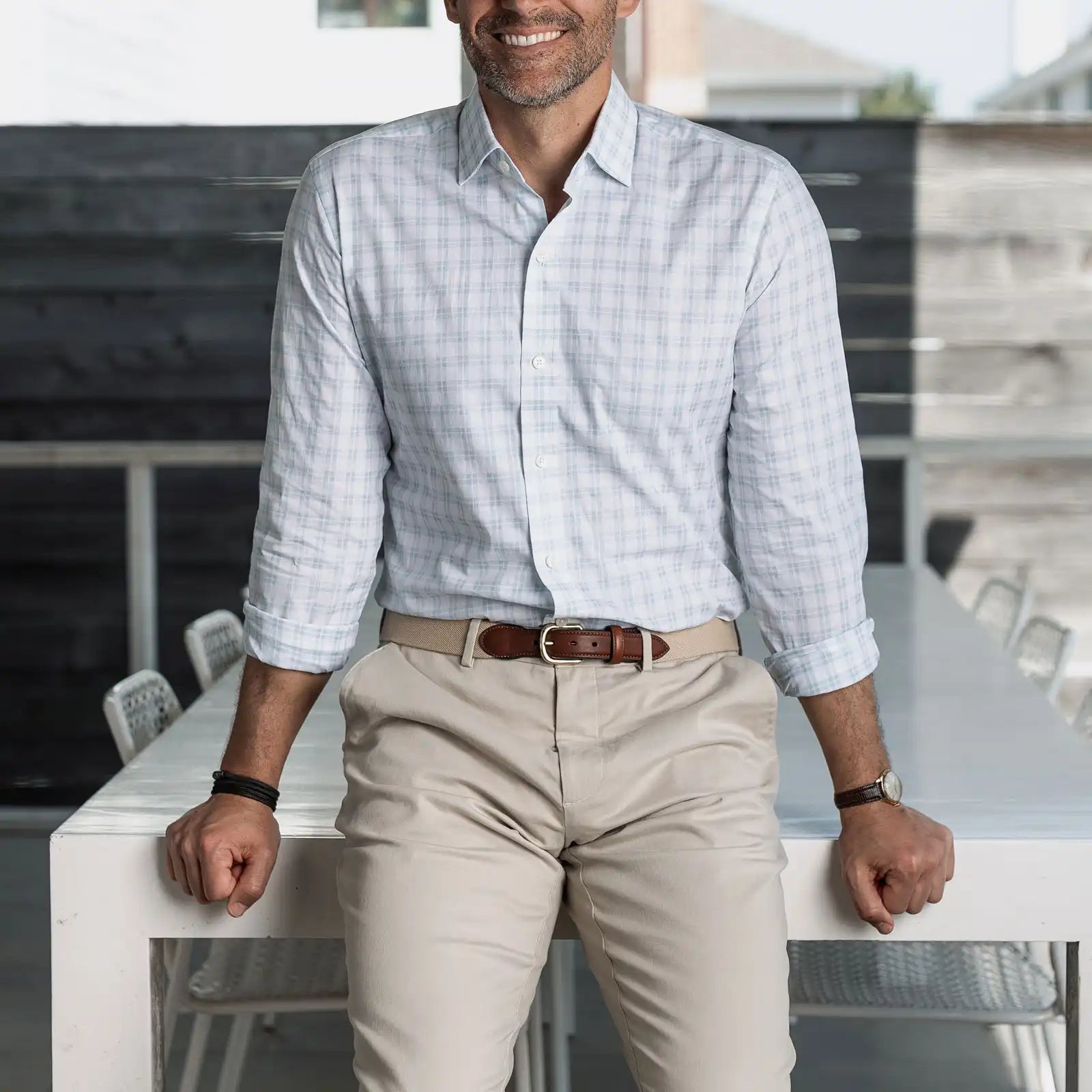 Man wearing the light green Ellis checkered shirt and beige pants, standing in an outdoor setting.