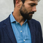 Closeup of the collar of the Ledbury Cambell chambray shirt worn with a sport coat over it. 
