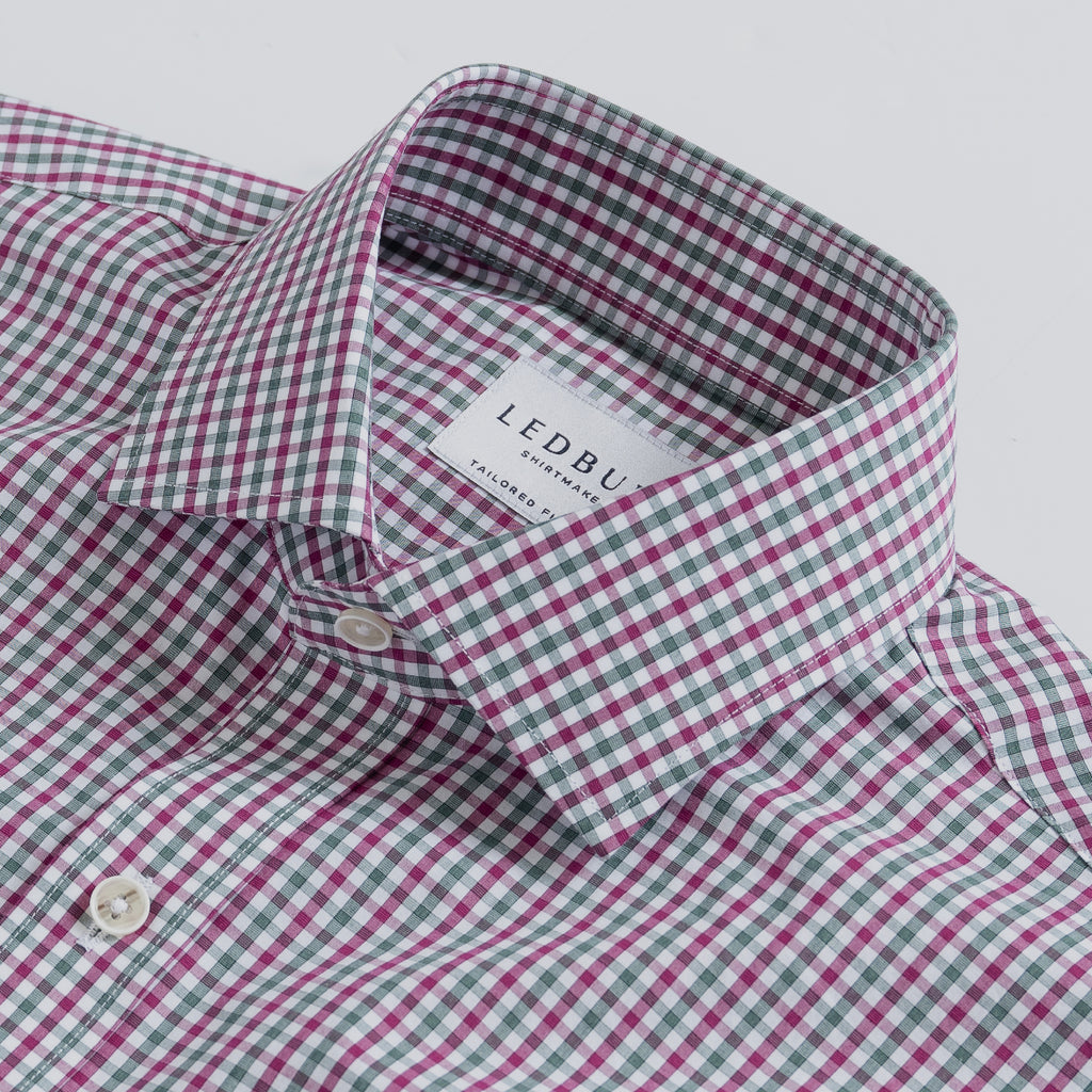 Closeup of the collar of a berry red and dark green checked men's dress shirt