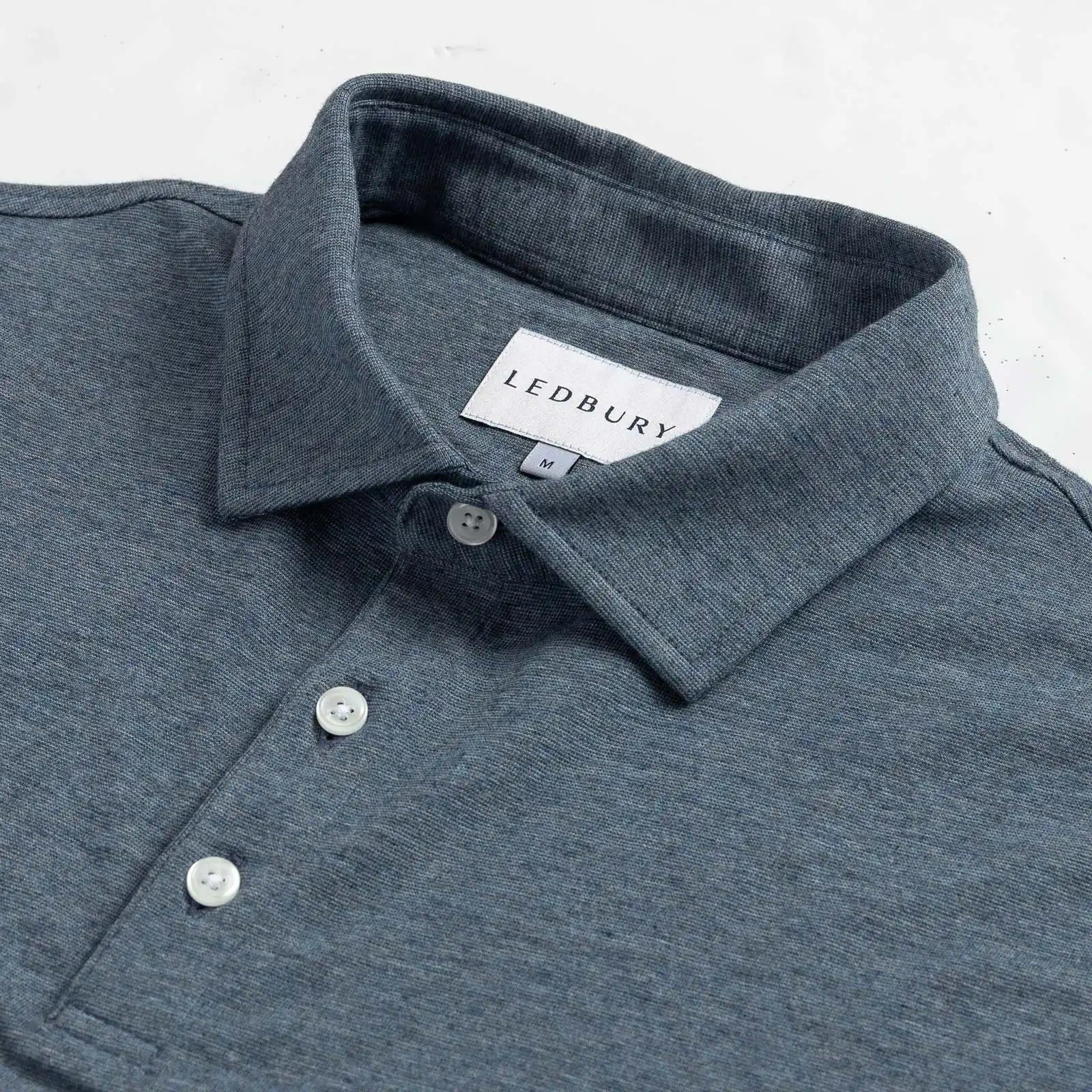 Close-up of the collar on the Ledbury Freeman Knit Custom Polo in Bay Blue
