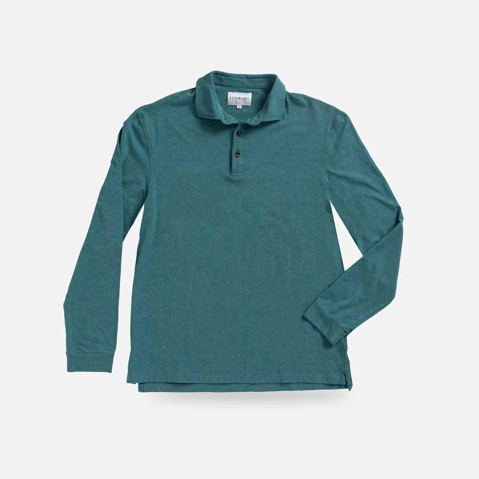A teal green long-sleeve polo shirt with a three-button placket, laid flat against a light gray background.