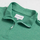 Close-up of quarter-zip collar and Ledbury label on Freeman Sport Quarter Zip in Parakeet Green