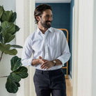 Model wearing a poplin custom fit dress shirt with wrinkle-resistant finish