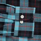 Close-up of Ledbury Olson Plaid double button barrel cuff in teal and navy plaid cotton chambray