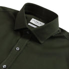 Close-up of a dark olive green LEDBURY long-sleeve shirt, showing the collar, button-down front, and LEDBURY brand label.