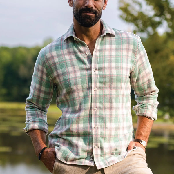 Man wearing a sage green, cream, grey and light pink flannel shirt by Ledbury.